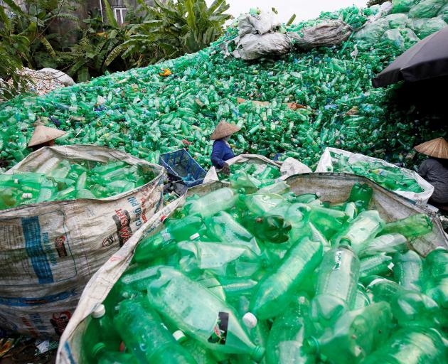 Vietnamese women work with recyclable plastic bottles at Xa Cau village, outside Hanoi. Photo:...