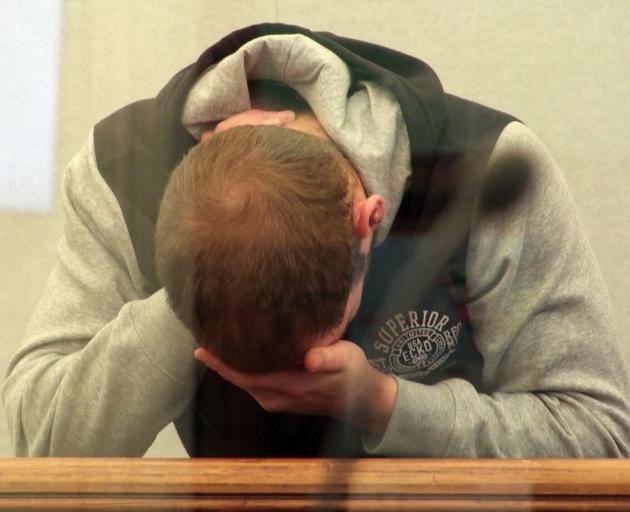 Brandon Macgregor (25) stood with his head down during sentencing so his face could not be...