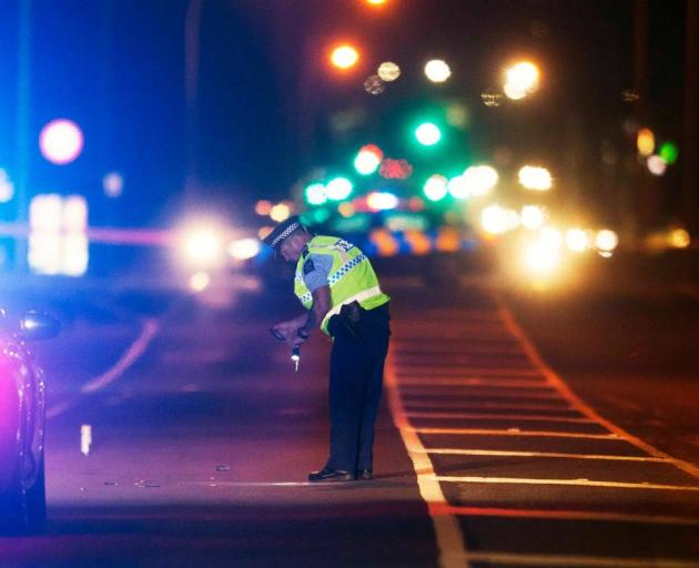 Police investigate the crash scene on Te Ngae Rd where a pedestrian was hit by a car. Photo: NZME