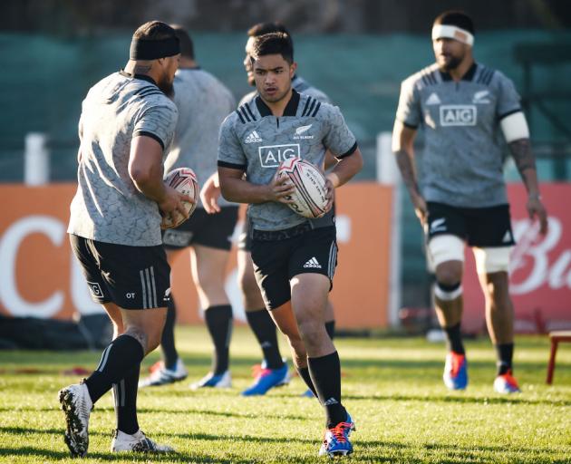 Otago and Highlanders first five-eighth Josh Ioane runs with the ball past Ofa Tuungafasi (left) during an All Blacks training session at San Isidro Club in Buenos Aires yesterday. Photo: Getty Images