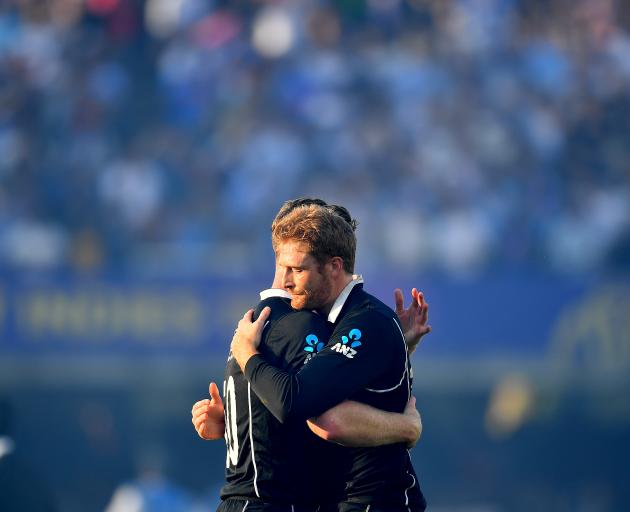 Jimmy Neesham and Martin Guptill console one another after their heartbreaking World Cup final ...