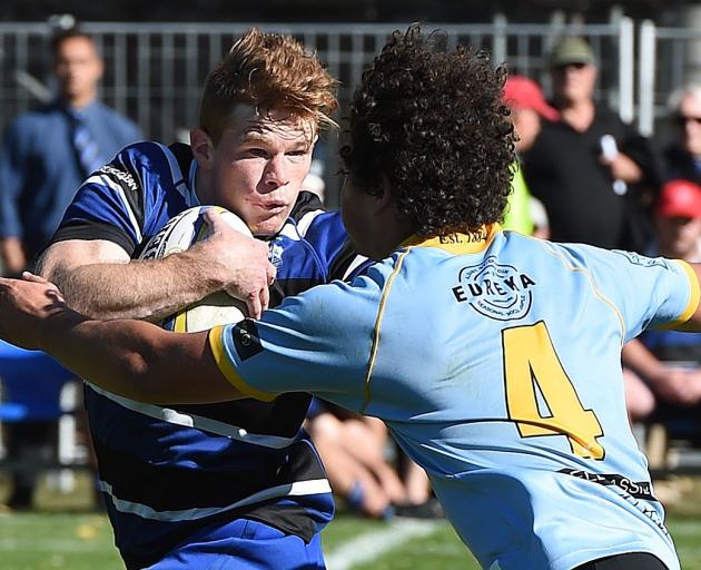 Kaikorai first five-eighth Ben Miller fends University lock Ben Reidy during a premier game at...