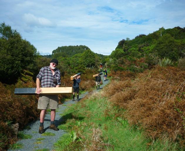 Forest & Bird Southland member Lloyd Esler leads volunteer workers at the Lenz Reserve in the...