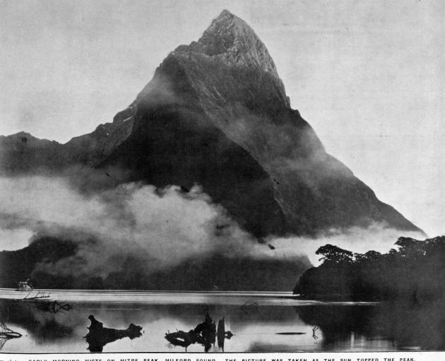 Early morning mists surround Mitre Peak, Milford Sound. — Otago Witness, 16.7.1919   COPIES OF...