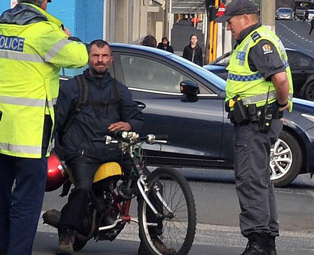 Michael Herzog is pulled over by Dunedin police on his home-made petrol-powered hybrid of motor...