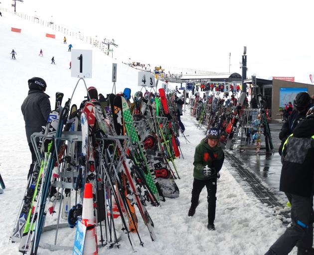 Visitors and snow gear outside Coronet Peak’s base building this week. PHOTO: GUY WILLIAMS