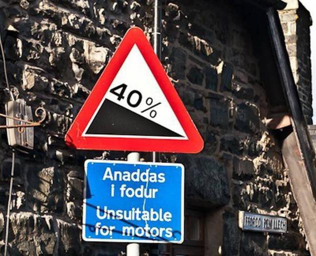 A sign at the top of Pen Ffordd Llech in Harlech, Wales, warns drivers of a slope of 40 per cent ...