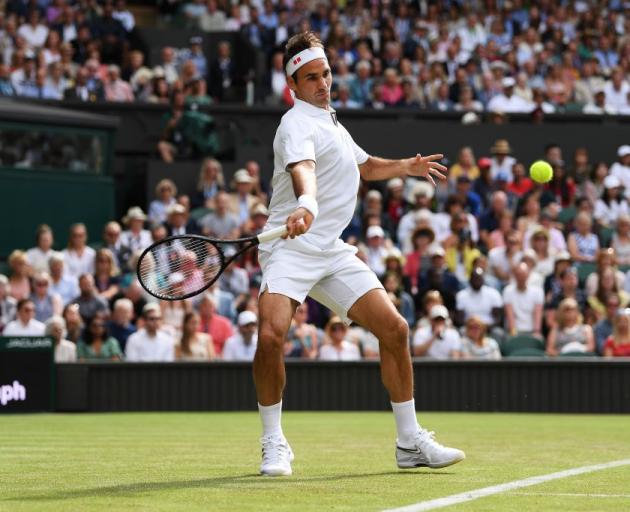 Roger Federer prepares to play a forehand during his first round win at Wimbledon. Photo: Getty...