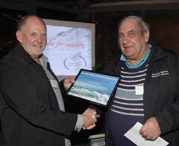Search and Rescue district co-ordinator Brian Benn (left) presents Keith Simon with an...