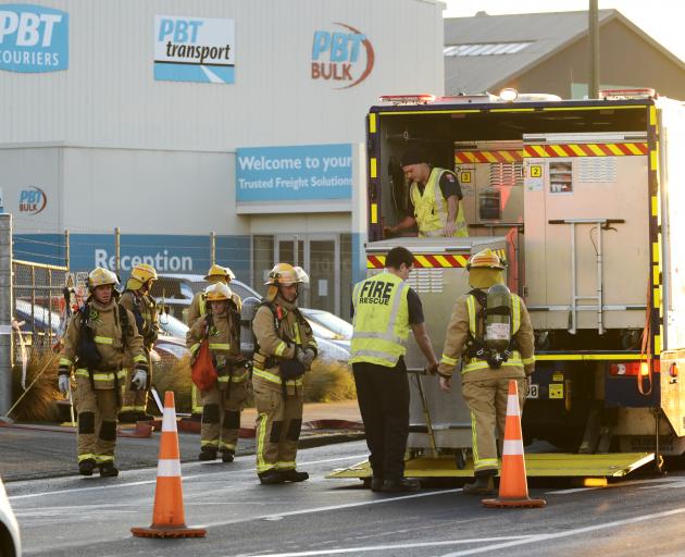 Firefighters unload specialist decontamination equipment at the scene of a chemical spill in Strathallan St this morning. Photo: Gerard O'Brien 