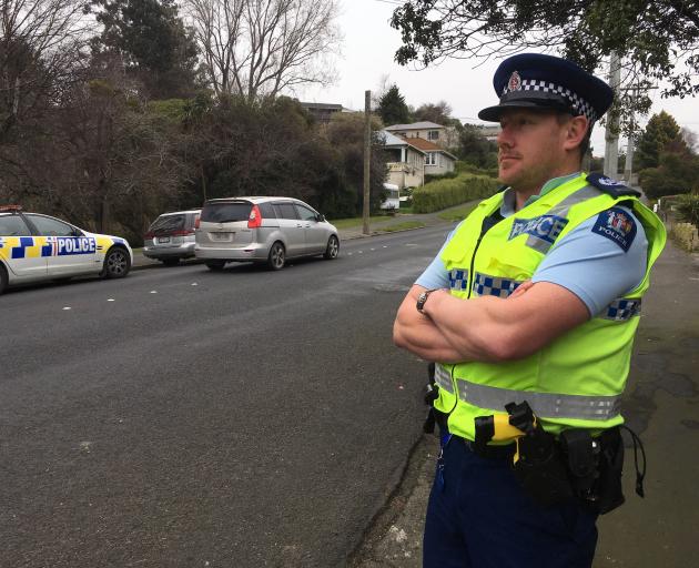 Senior Sergeant Jared Kirk watches motorists in Corstorphine Rd where a mobile speed-camera site has generated the most tickets in the city. Photo: Shawn McAvinue