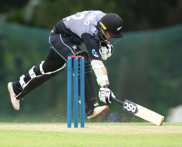 New Zealand’s Colin Munro sprints to make his ground in the warm-up T20 match against the Sri...