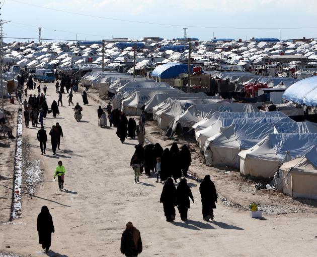 Women walk through Al-Hol displacement camp in Northern Syria. Photo: Reuters