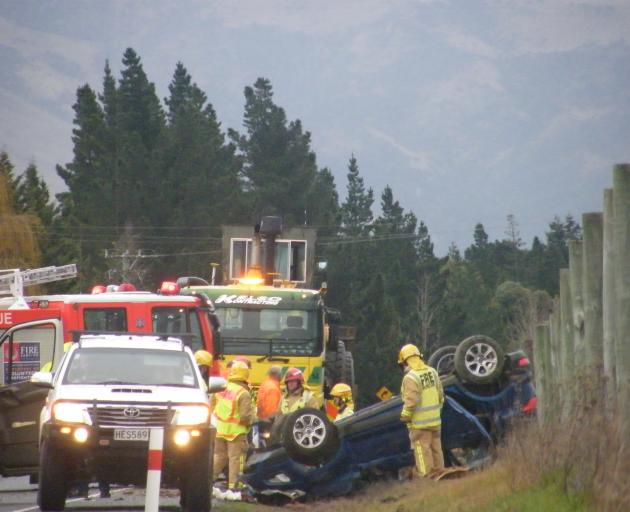A car on its roof after it rolled near Alexandra this afternoon. Photo: Adam Burns