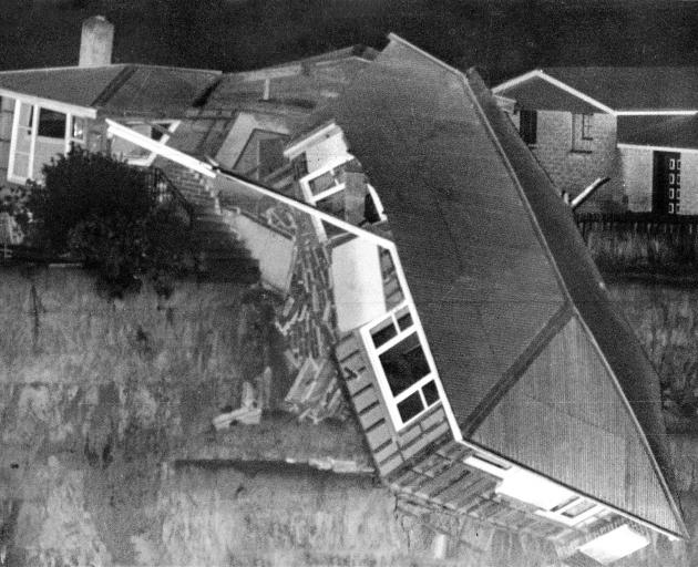 A house drops into the widening chasm as the Abbotsford landslip rumbles downhill. PHOTO: ODT...