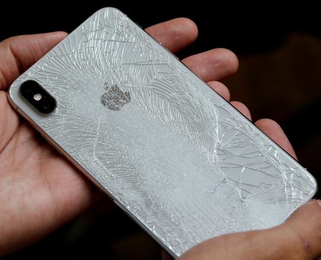 A worker refurbishes an Apple Iphone. Photo: Reuters