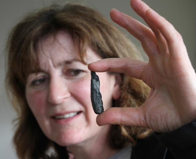 Kaka Point resident Raewyn Snell holds a gravel shard removed from her tyre, following her fifth...