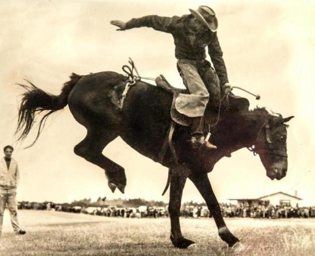 Brian Wilson rides a bucking horse during a rodeo in Rangiora in the 1950s. Photo: Supplied via Star.Kiwi