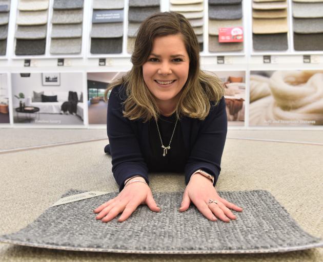 Flooring consultant Sarah Eckhoff with wool carpet from Cavalier Bremworth. Photo: Gregor Richardson
