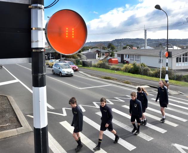 Tahuna Normal Intermediate pupils (from left) Regan Buchan (12), Max Stevenson (12), Alex McKeever (11), Isabella Inglis (12) and Aria Kerekere (13) cross Victoria Rd with help from a new device, created by Dunedin inventor Larry Burns, that alerts driver