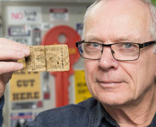 Dennis Shrimpton holds a 1738 United States bank note he brought off eBay. Written on it is 'death to counterfeits'. As a owner of a hardware store, Mr Shrimpton has had his own run-in with a customer attempting to use a fake note. Photo: Martin Hunter