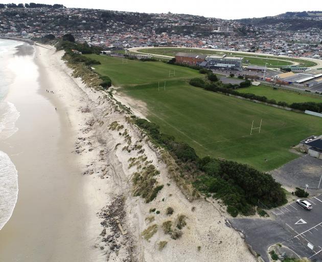 An aerial photograph shows the steep scarp, rocks and other rubble left behind after erosion at...