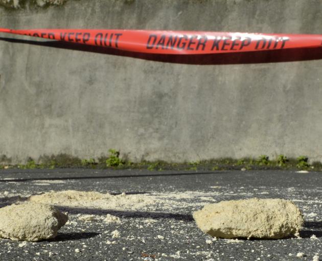 Part of the parapet of Hanover Hall lies on the footpath, likely after heavy rain on Sunday.
