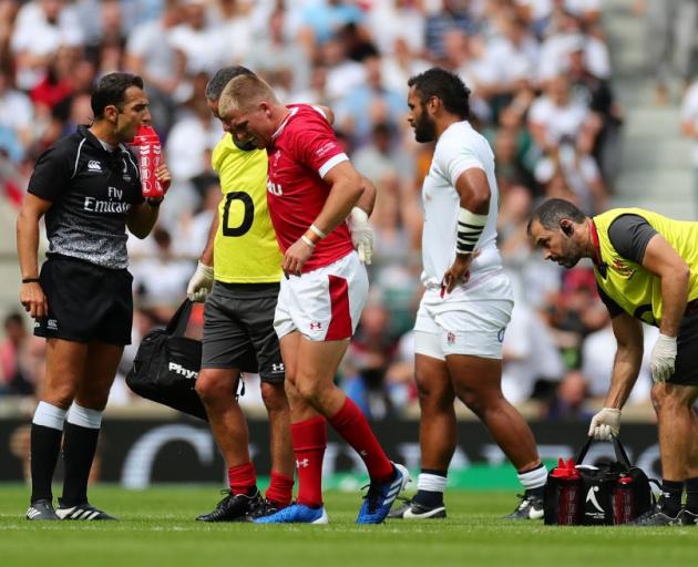 Gareth Anscombe leaves the field after being injured against England at the weekend. Photo: Getty...