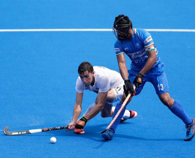 Black Sticks forward Jacob Smith (left) competes for the ball with India defender Harmanpreet Singh in the final of the Ready, Steady Tokyo Olympic test tournament yesterday. India won 5-0. Photo: Getty Images