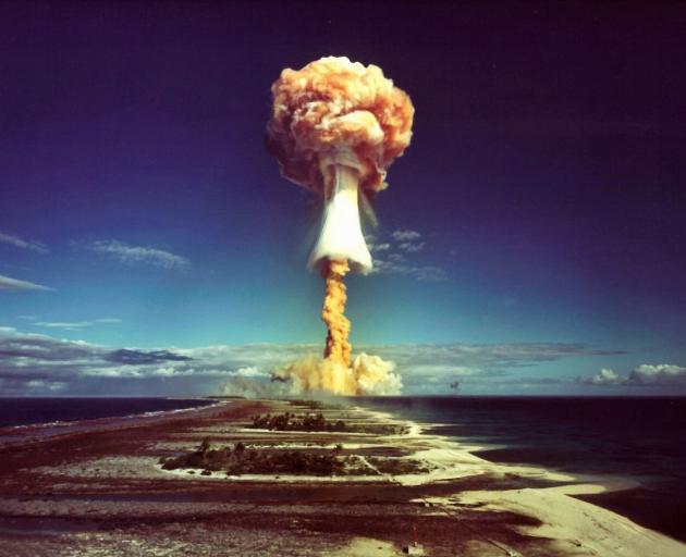 A mushroom cloud after the explosion of a French atomic bomb above the atoll of Mururoa, also...