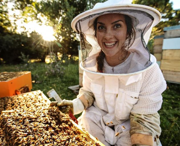 Southland beekeeper Steph Munro in her happy place checking her bees. PHOTOS: JAMES JUBB