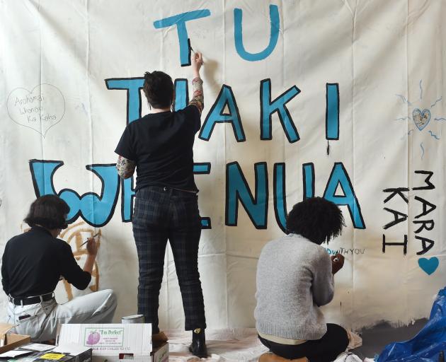 Students and volunteers came to the Otago University Clubs and Societies Building yesterday hear about the Ihumatao protest and to create a mural for the protectors. Photo: Peter McIntosh
