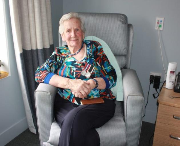 Nettie Glass wears the medals she was awarded for her service during World War 2.  Photo: Gus...