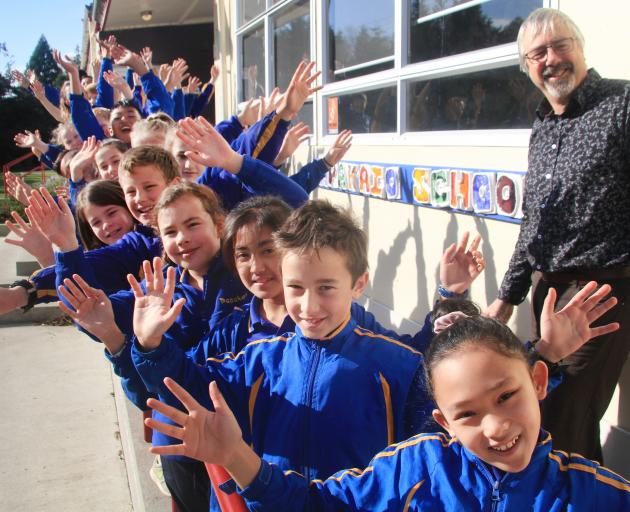 Celebrating the success of Papakaio School are Room 5 - year 5 and 6 pupils - and principal Gary...