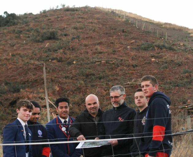 St Kevin’s College pupils (from left) Marc Boardman, Tai Williams and Jerome Misiloi look over...