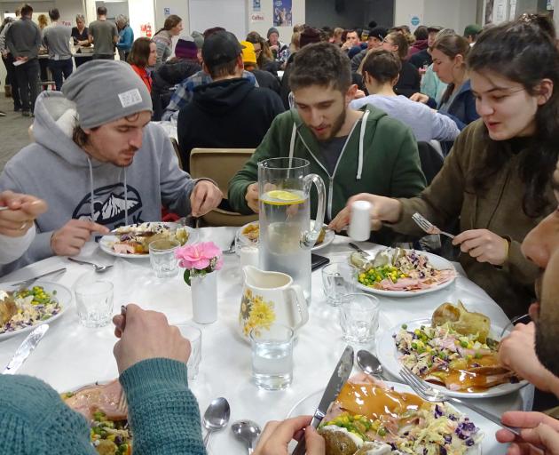 Wanaka-based ski workers from around the world enjoy the free fortnightly meal at the St Andrew's...