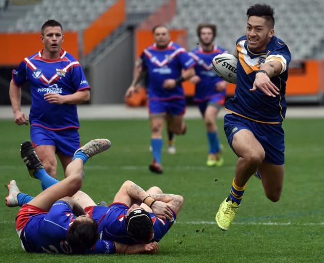 Otago Whalers back Willie Time smashes through two Tasman players during a match at Forsyth Barr...