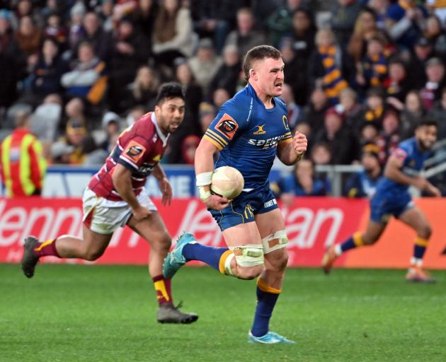 Otago's Dylan Nel runs away from Southland's Moses Faletolu to score during the Ranfurly Shield...