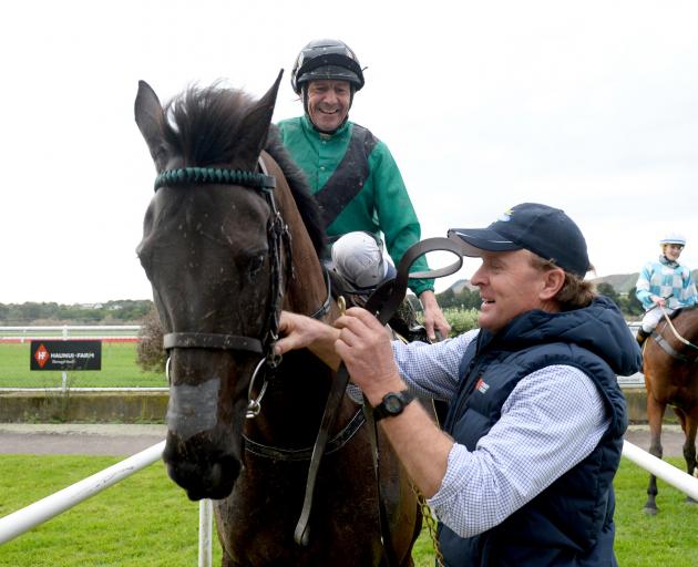Waipukurau trainer and part-owner Simon Wilson greets jockey Chris Johnson in the birdcage at...