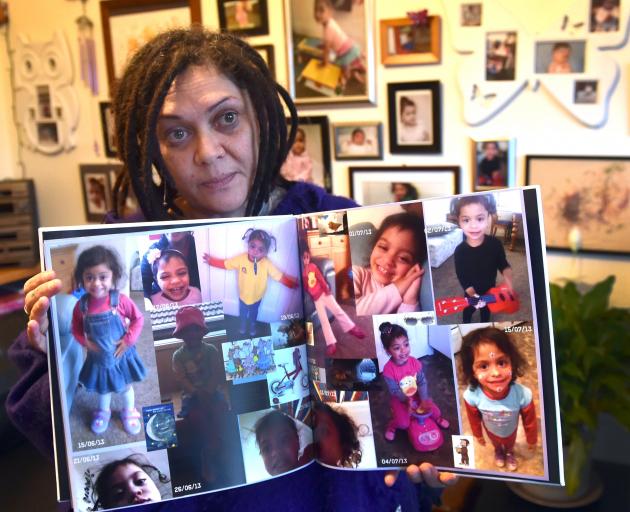 Tracey Elvins holds images of her daughter Hineihana Sosefina Mausii, who died six years ago...