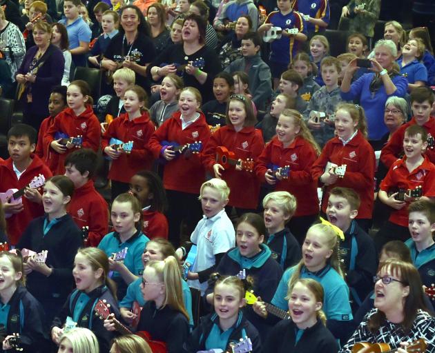 Plucky primary and intermediate pupils strum their way through a song at the 10th Music Education...