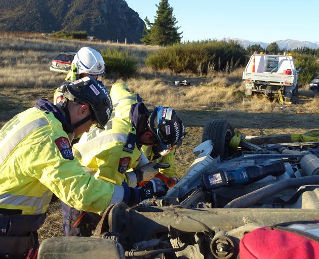 Crash rescue team medic Jodie Rainsford continually checks on the trapped patient’s condition as...