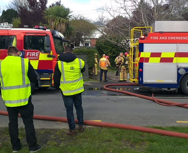 Fire crews at the scene of a house fire in Hillsborough on Tuesday. Photo: Mark Sinclair. 