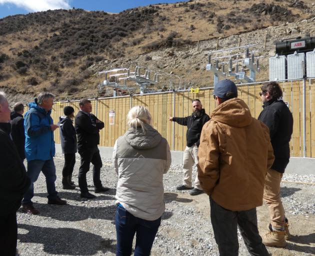 Pioneer Energy engineer Tony Jack takes residents on a tour of the site during yesterday's...