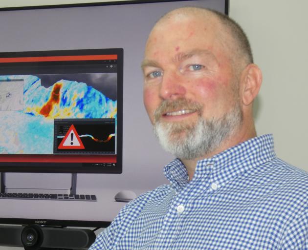 Xerra chief executive Steve Cotter shows shows the 3-D change detection project team's vision for an end product. Photo: Simon Henderson