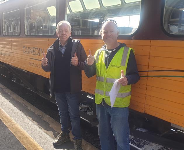 Rail and Maritime Union delegate Julian Evans (left) with train assistant Paul Jeffrey, whose hourly wage has just increased from $17.70 to $21.15 after 30-years service with the railway. PHOTO: RMTU