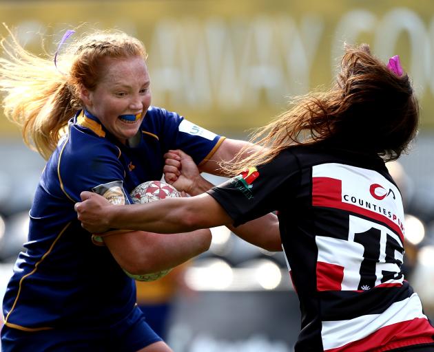 Trisha Hopcroft, of Otago Spirit, fends off Waikohika Flesher, of Counties-Manukau, during a...