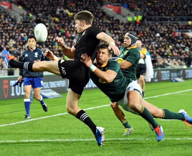 Handre Pollard tackles Beauden Barrett as he attempts to clear the ball. Photo: Getty Images 