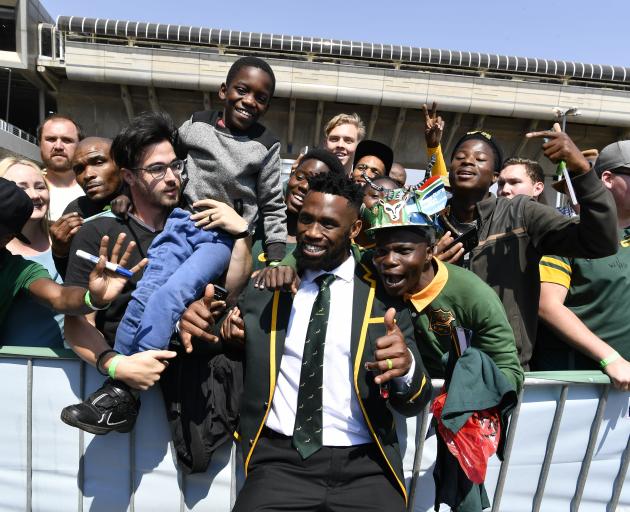 Springbok captain Siya Kolisi poses with fans during his side’s official send-off in Johannesburg...