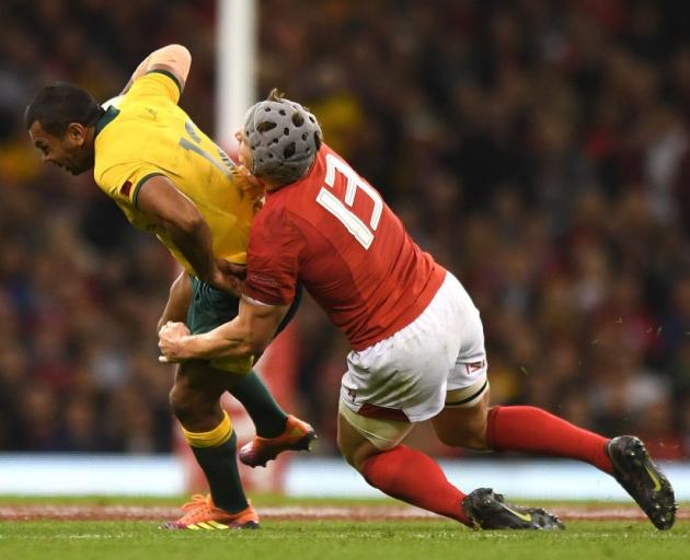 Wales' Jonathan Davies tackles Australia's Kurtley Beale in their match last year. Photo: Getty...